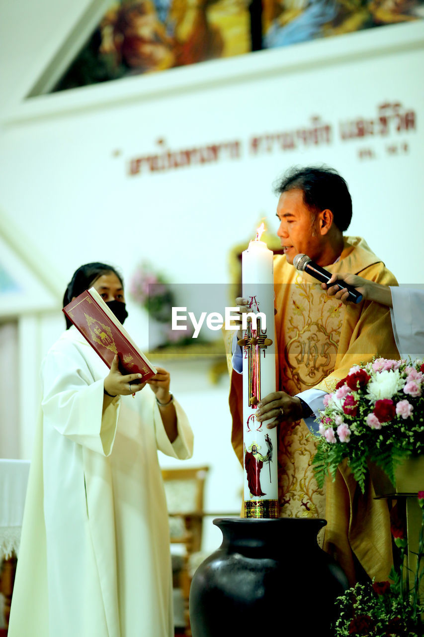 COUPLE HOLDING TEMPLE