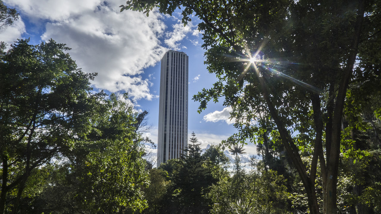 Low angle view of modern building against cloudy sky