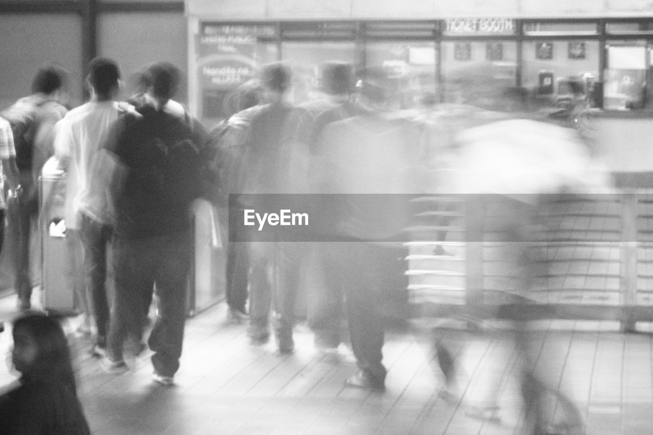 Blurred motion of people walking on street