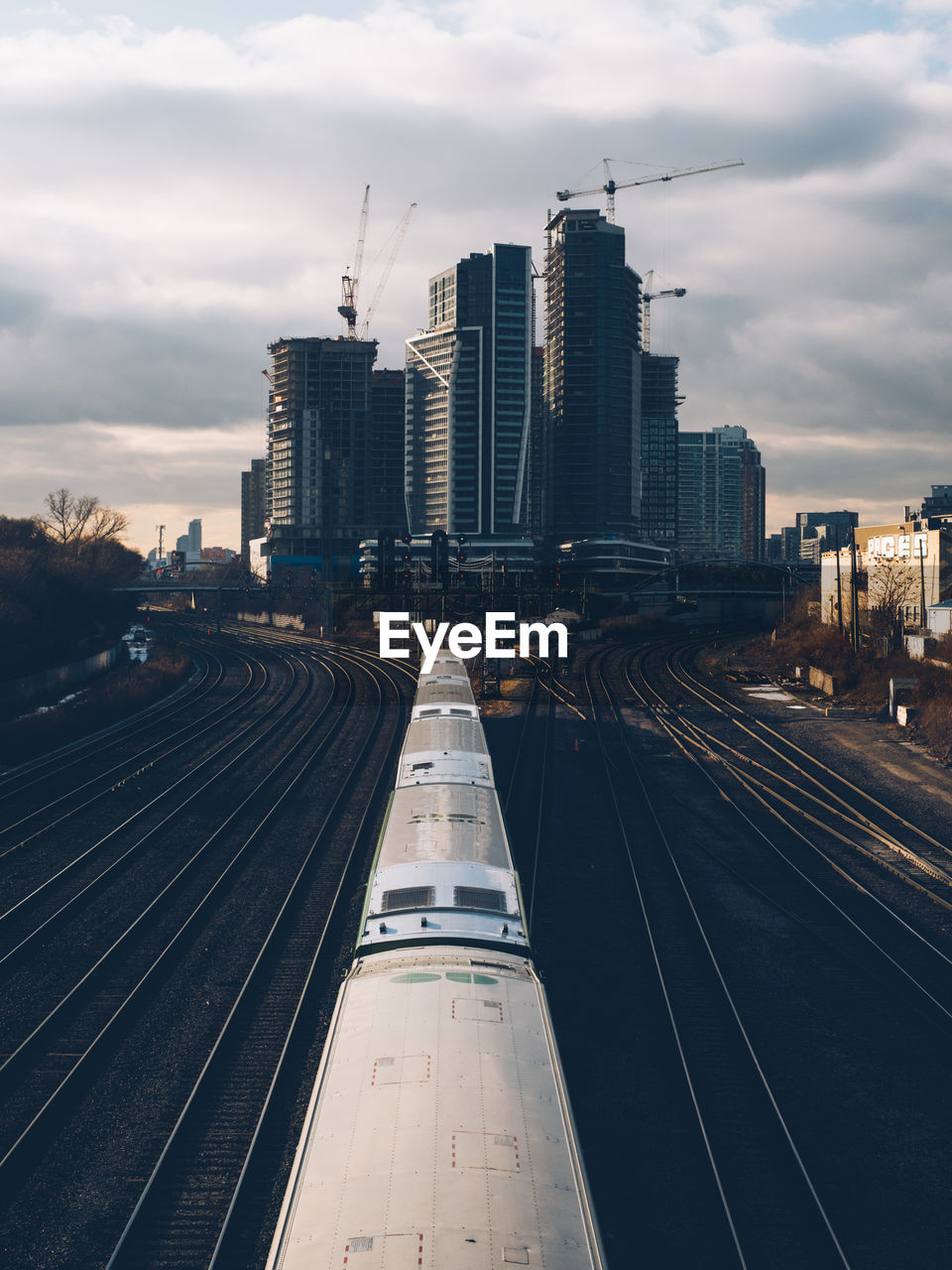 High aangle view of railroad tracks amidst buildings in city against sky