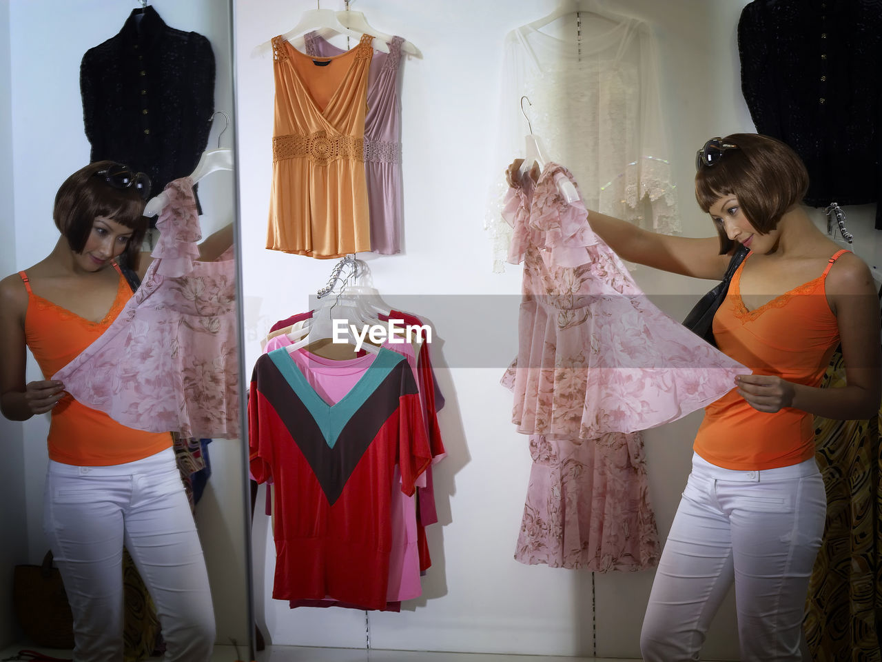 Woman with dress standing at shopping mall