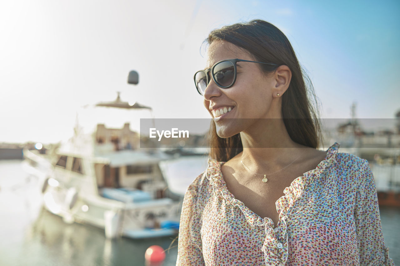 Beautiful young woman in luxury yacht bay, ready to sail. summer concept