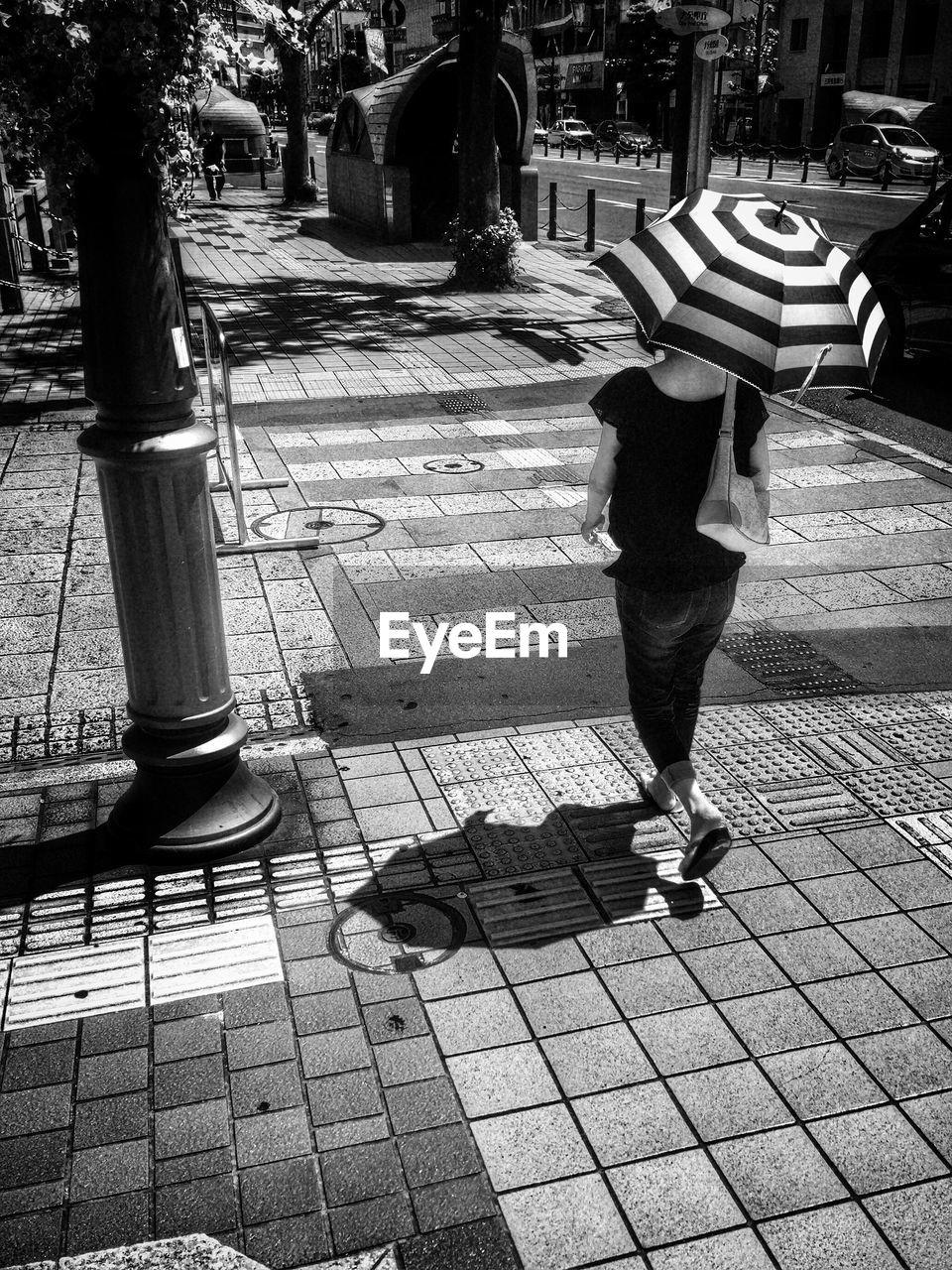 WOMAN WALKING ON SIDEWALK