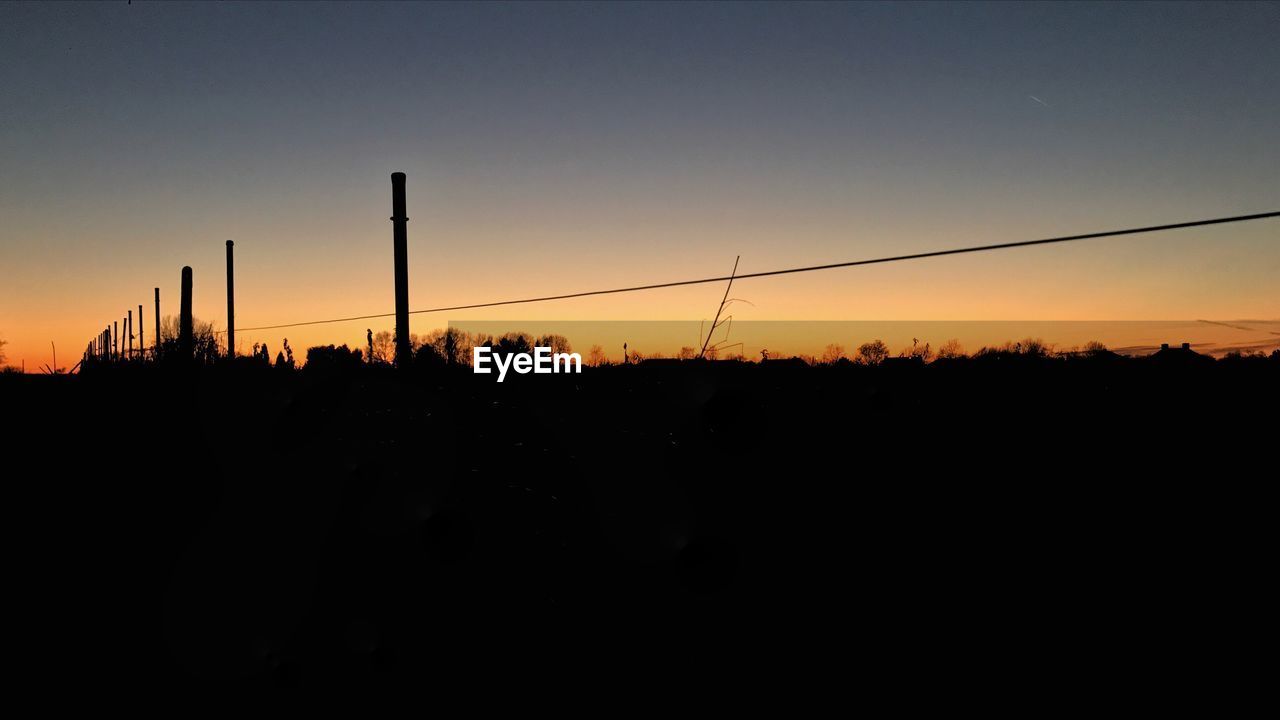 SILHOUETTE LANDSCAPE AGAINST SKY DURING SUNSET