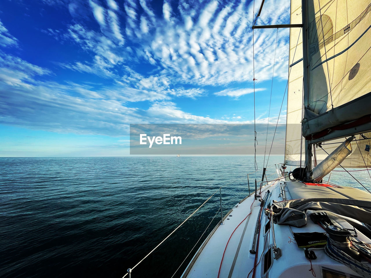 Sailboat sailing on sea against sky