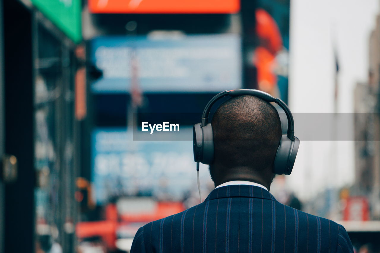 Rear view of businessman wearing headphones