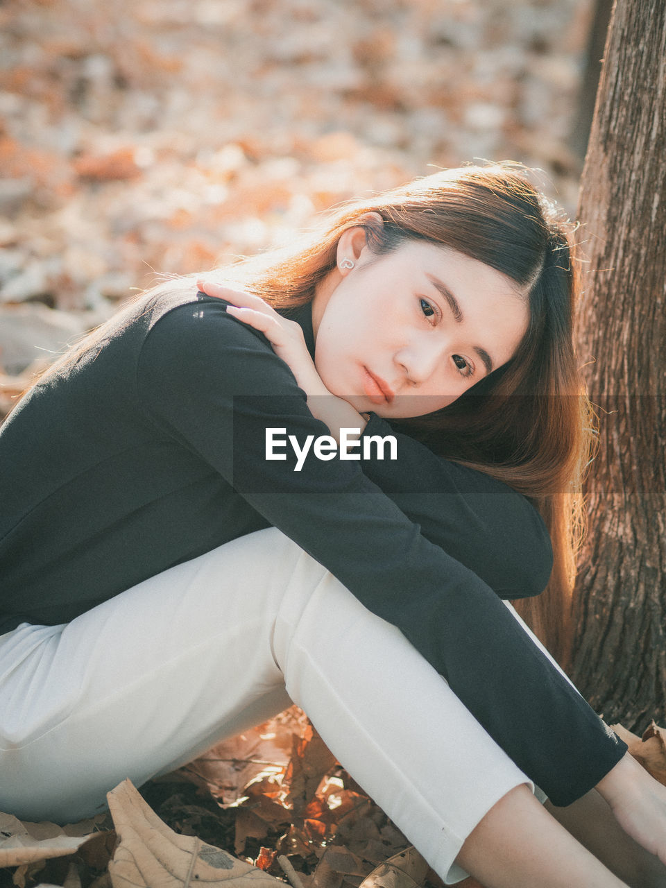 Portrait of teenage girl sitting on land