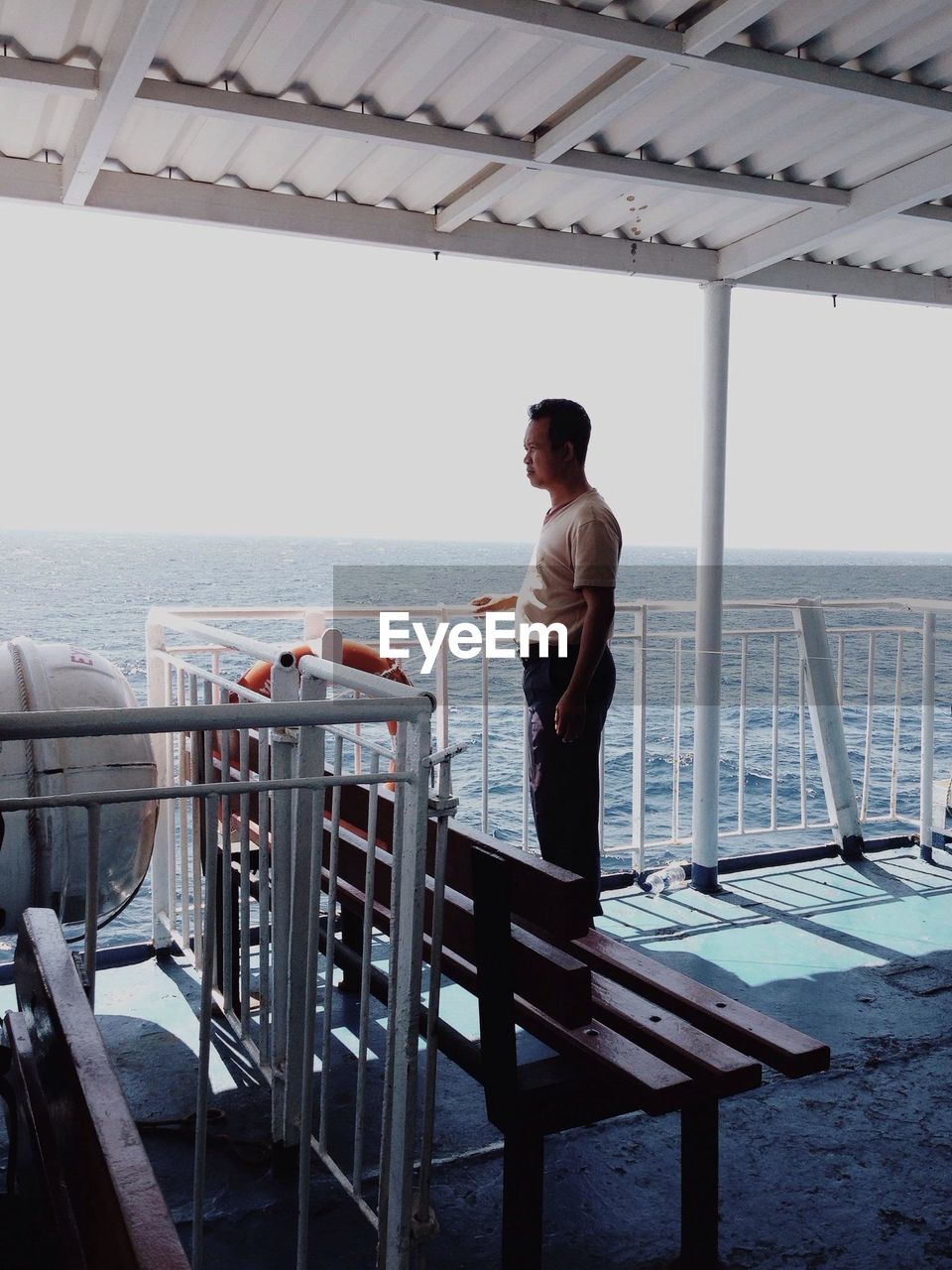 WOMAN STANDING ON PIER