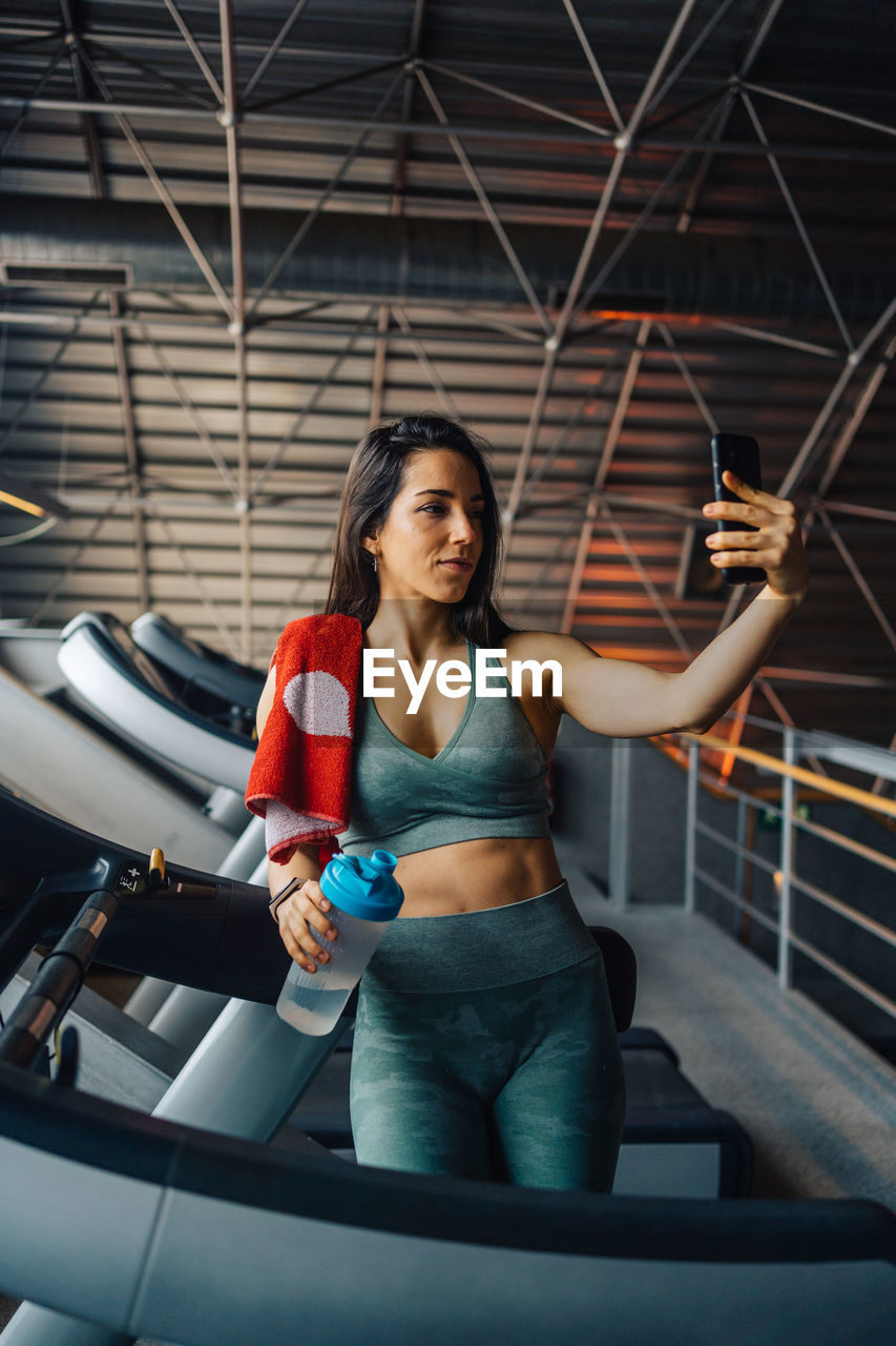 Portrait of young woman exercising in gym