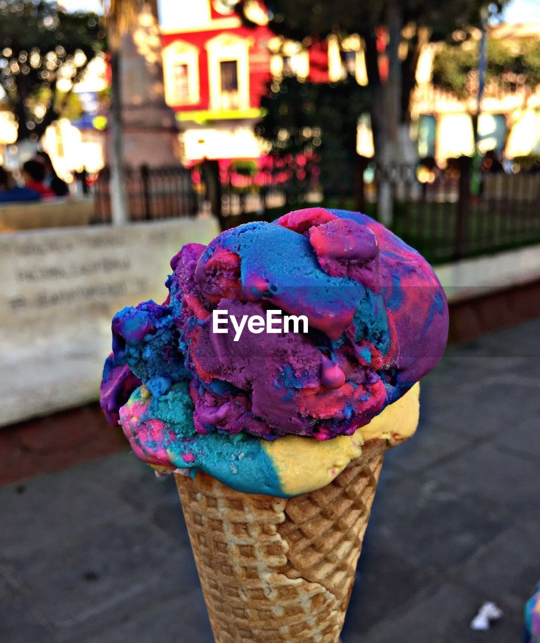 Close-up of ice cream cone over footpath