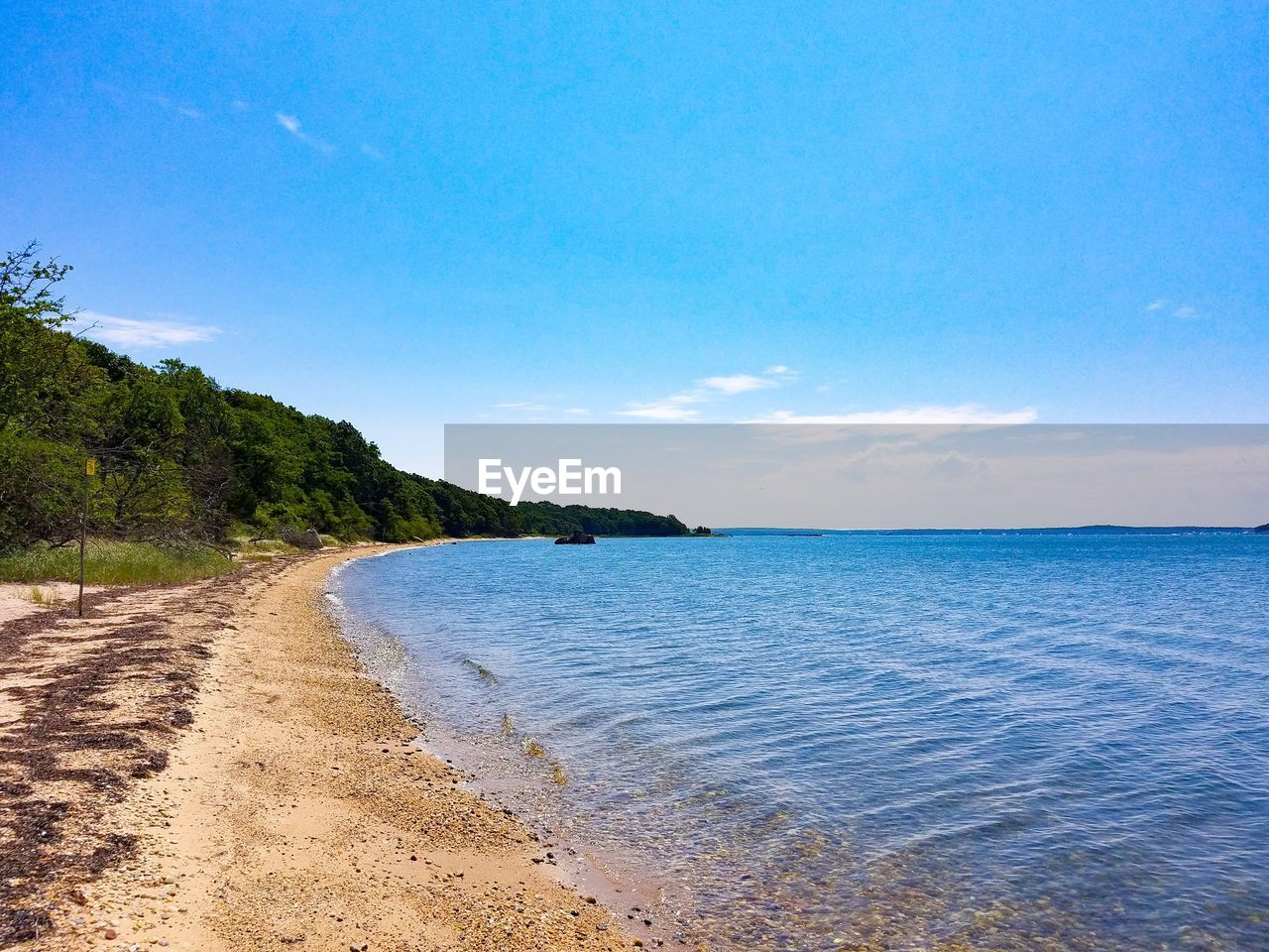 Scenic view of sea against blue sky