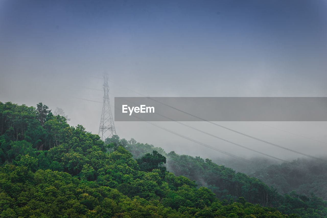 Scenic view of tree mountains against cloudy sky