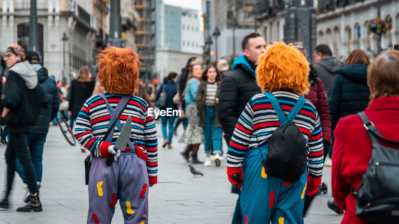 PEOPLE WALKING ON CITY STREET IN WINTER