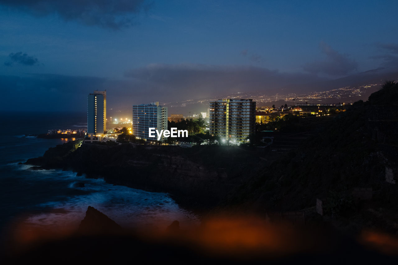 Illuminated buildings in city at night