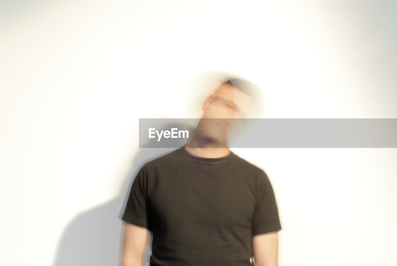 MIDSECTION OF MAN AGAINST CLEAR SKY