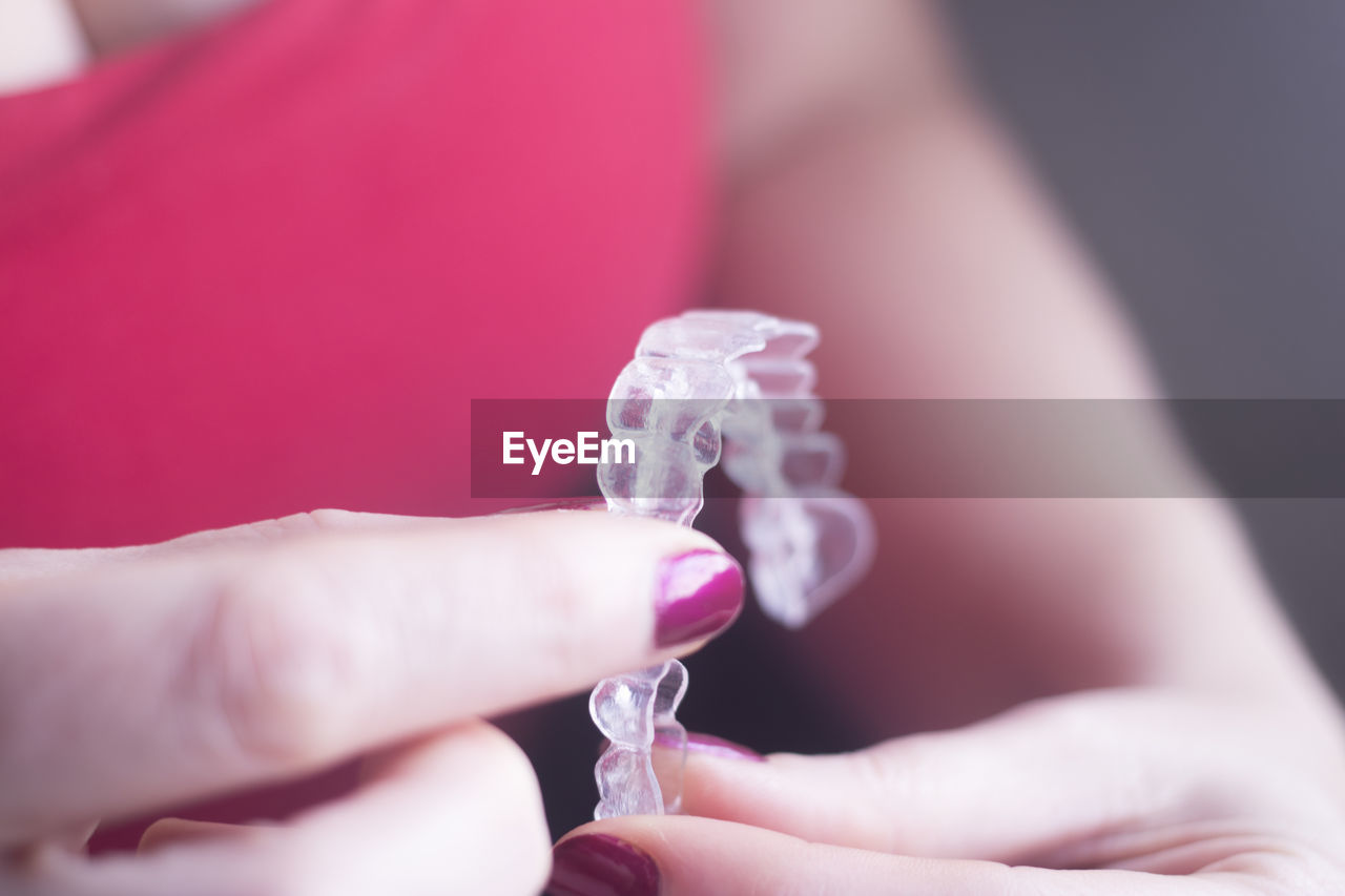 Close-up of woman holding braces