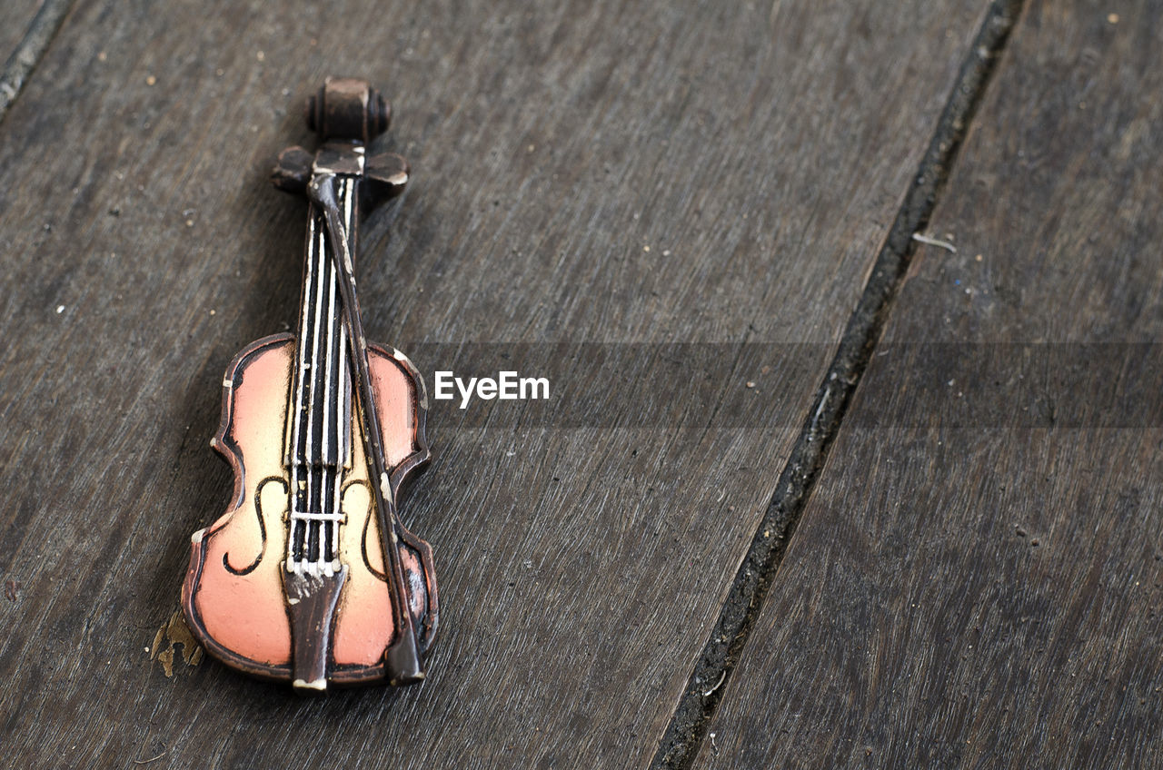 High angle view of figurine violin on table