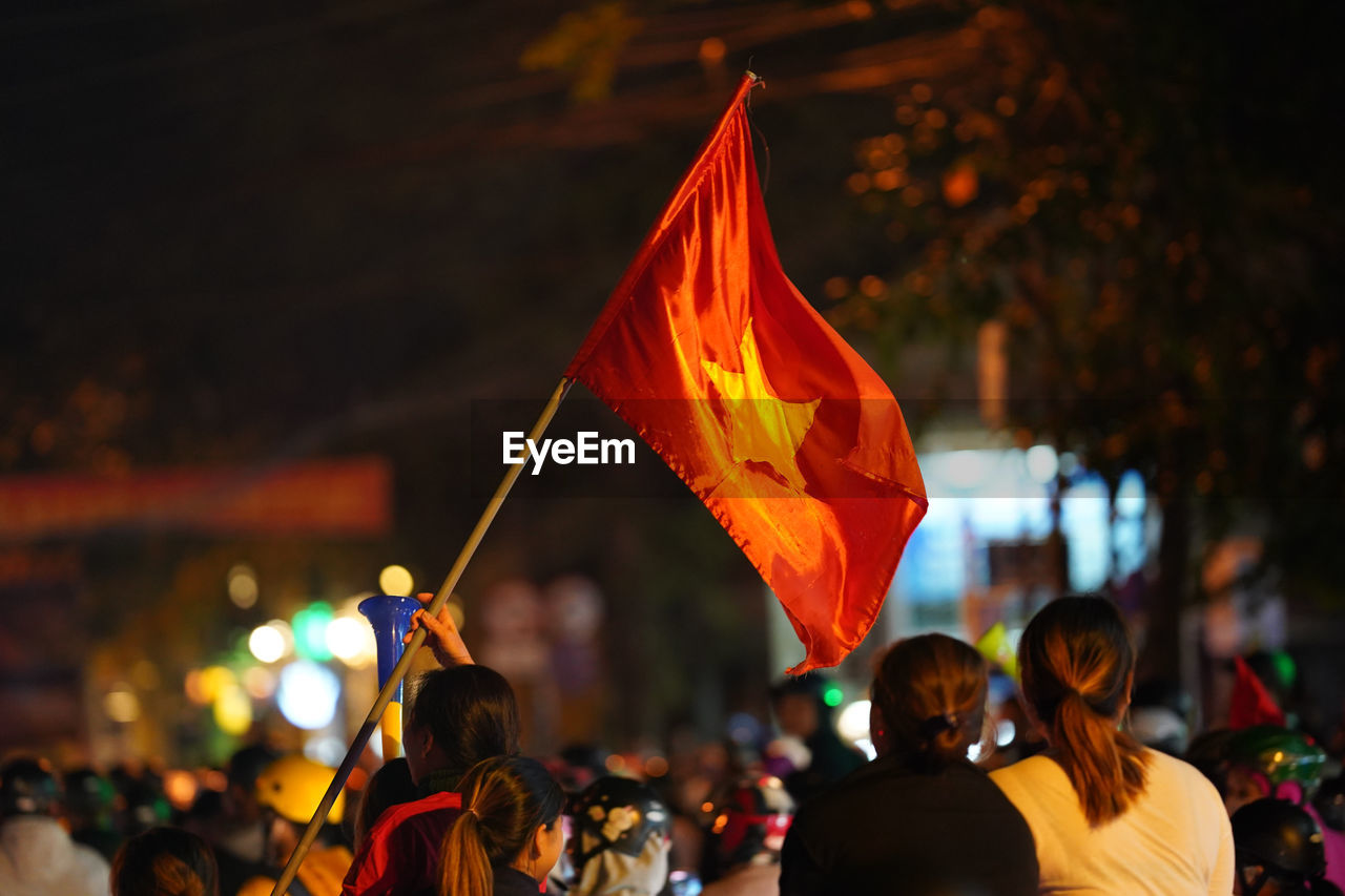 People on city street during event at night