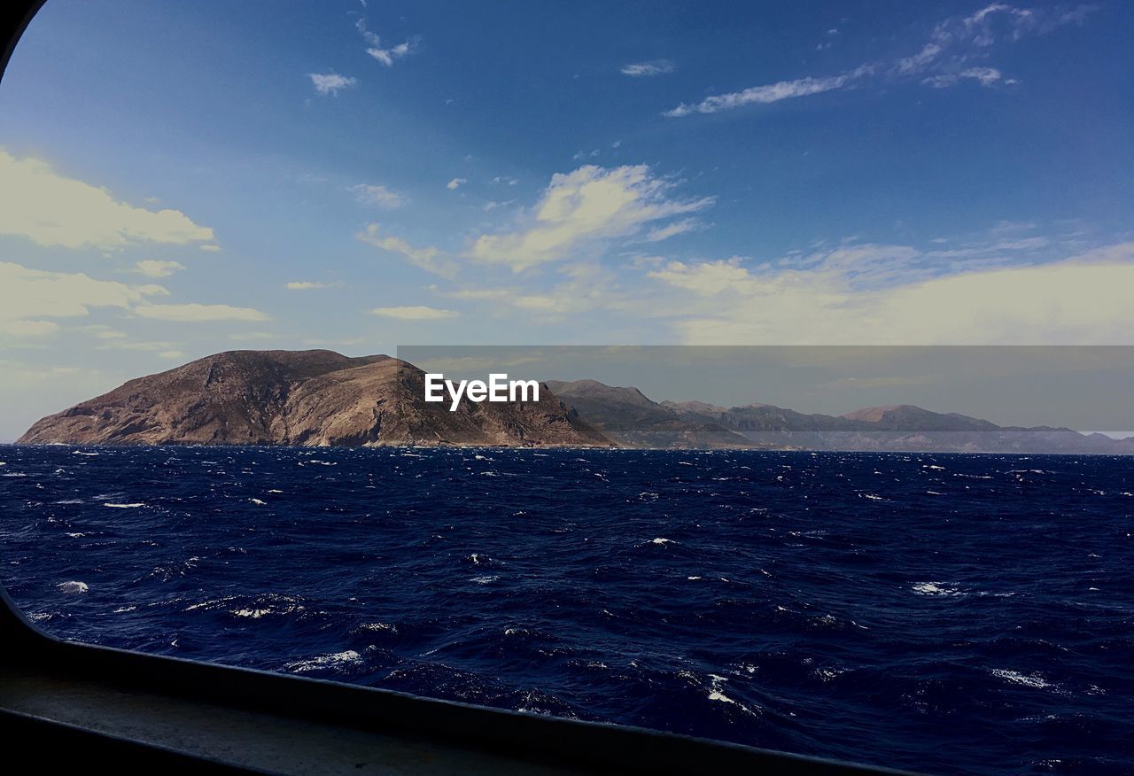 SCENIC VIEW OF SEA AND MOUNTAIN AGAINST SKY