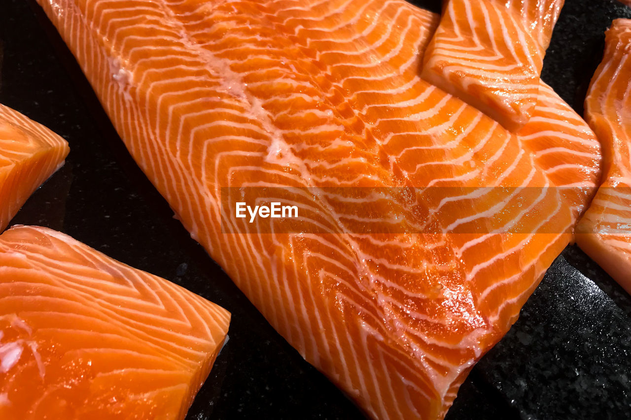 HIGH ANGLE VIEW OF ORANGE FISH ON FLOOR