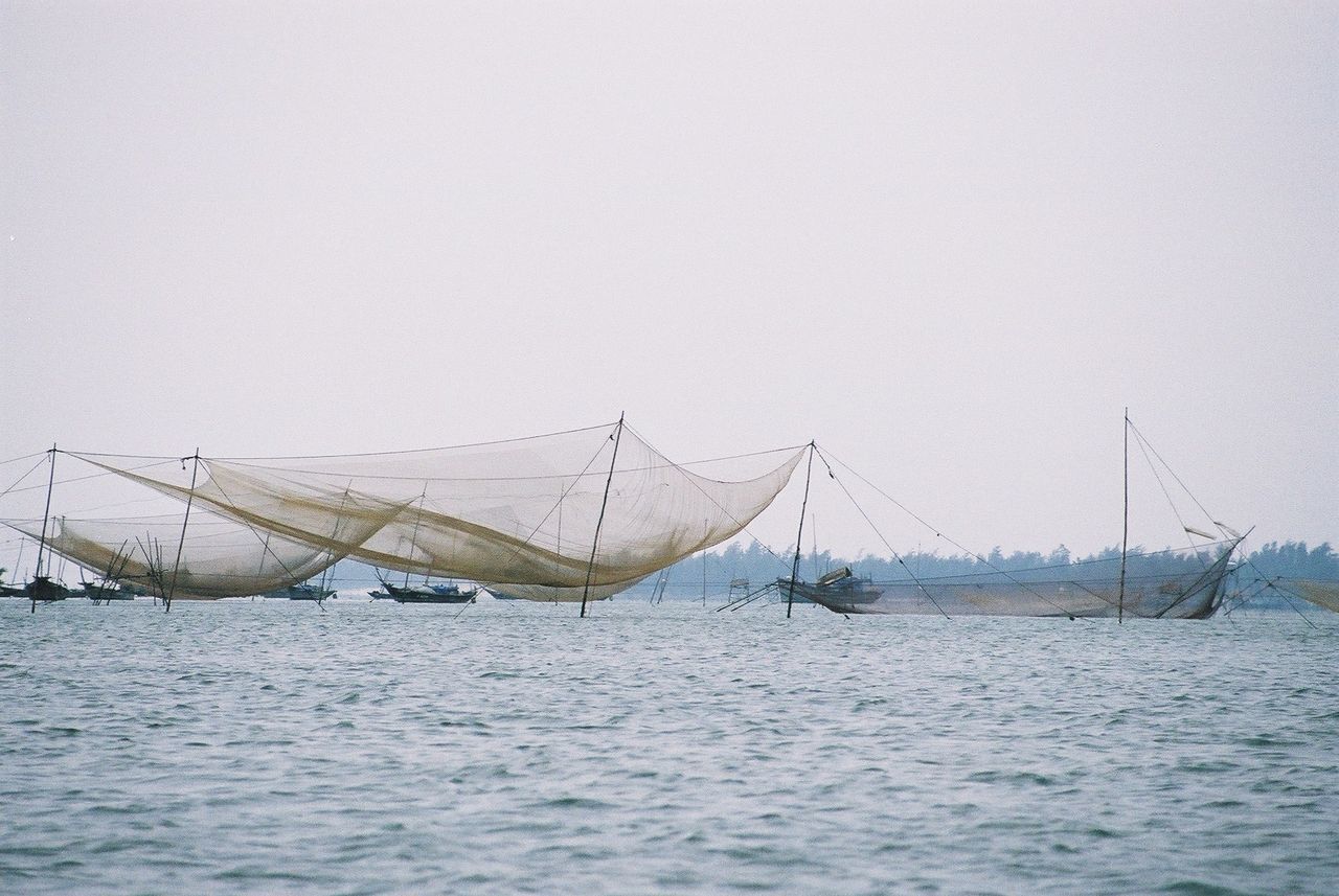 NAUTICAL VESSEL SAILING IN SEA AGAINST CLEAR SKY