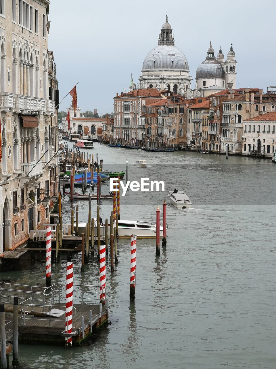 Boats in canal by buildings in city, grand canal, venice