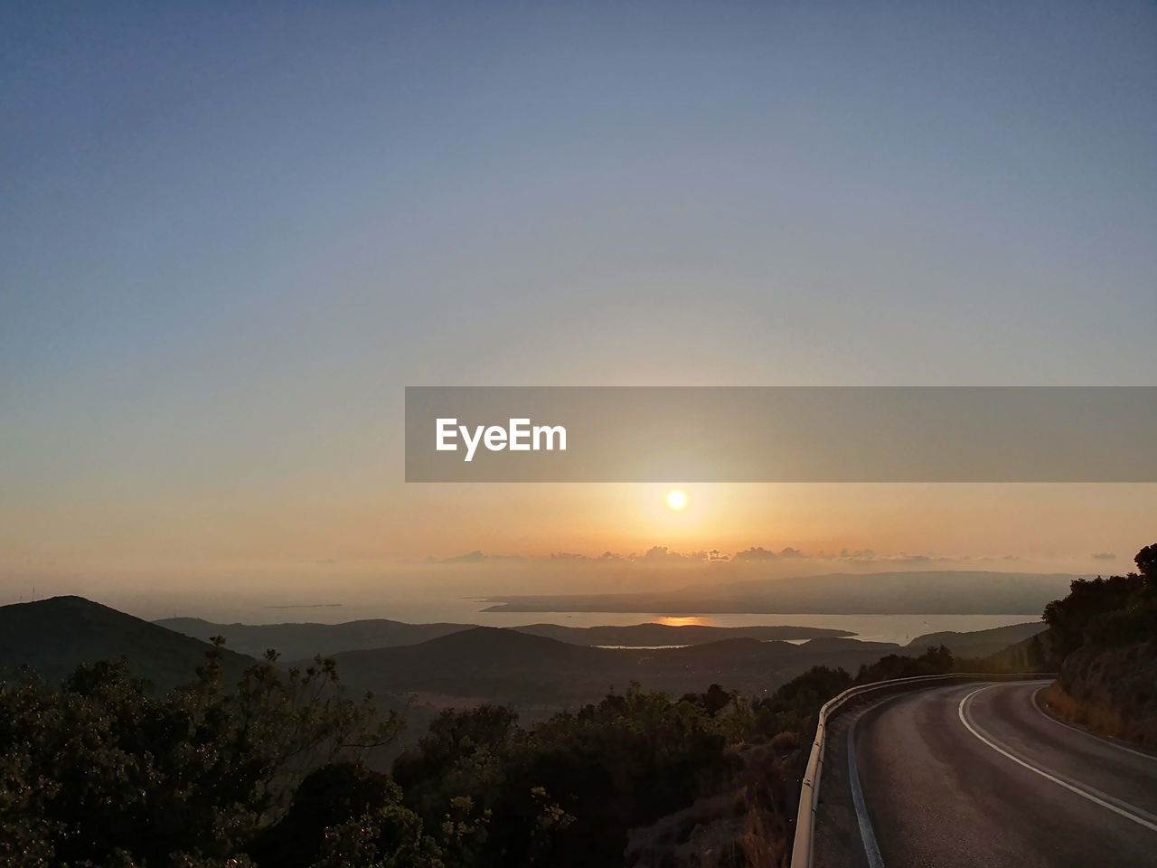 PANORAMIC VIEW OF ROAD AGAINST SKY DURING SUNSET