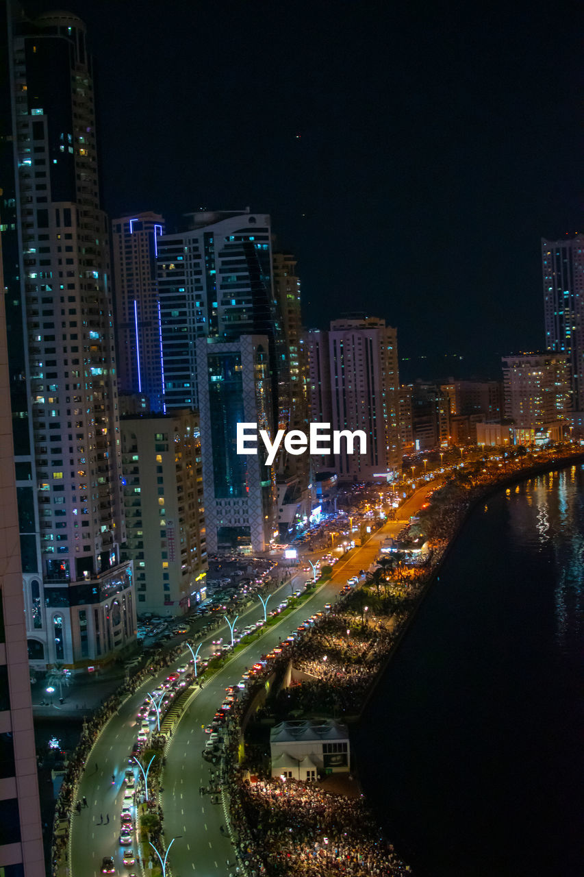 High angle view of illuminated buildings in city at night