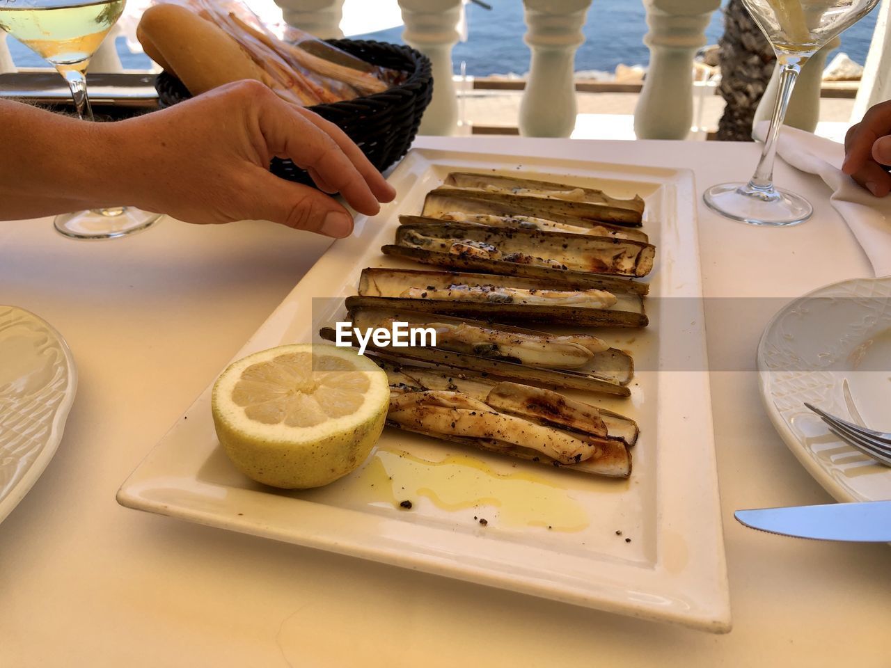 MIDSECTION OF WOMAN PREPARING FOOD ON TABLE