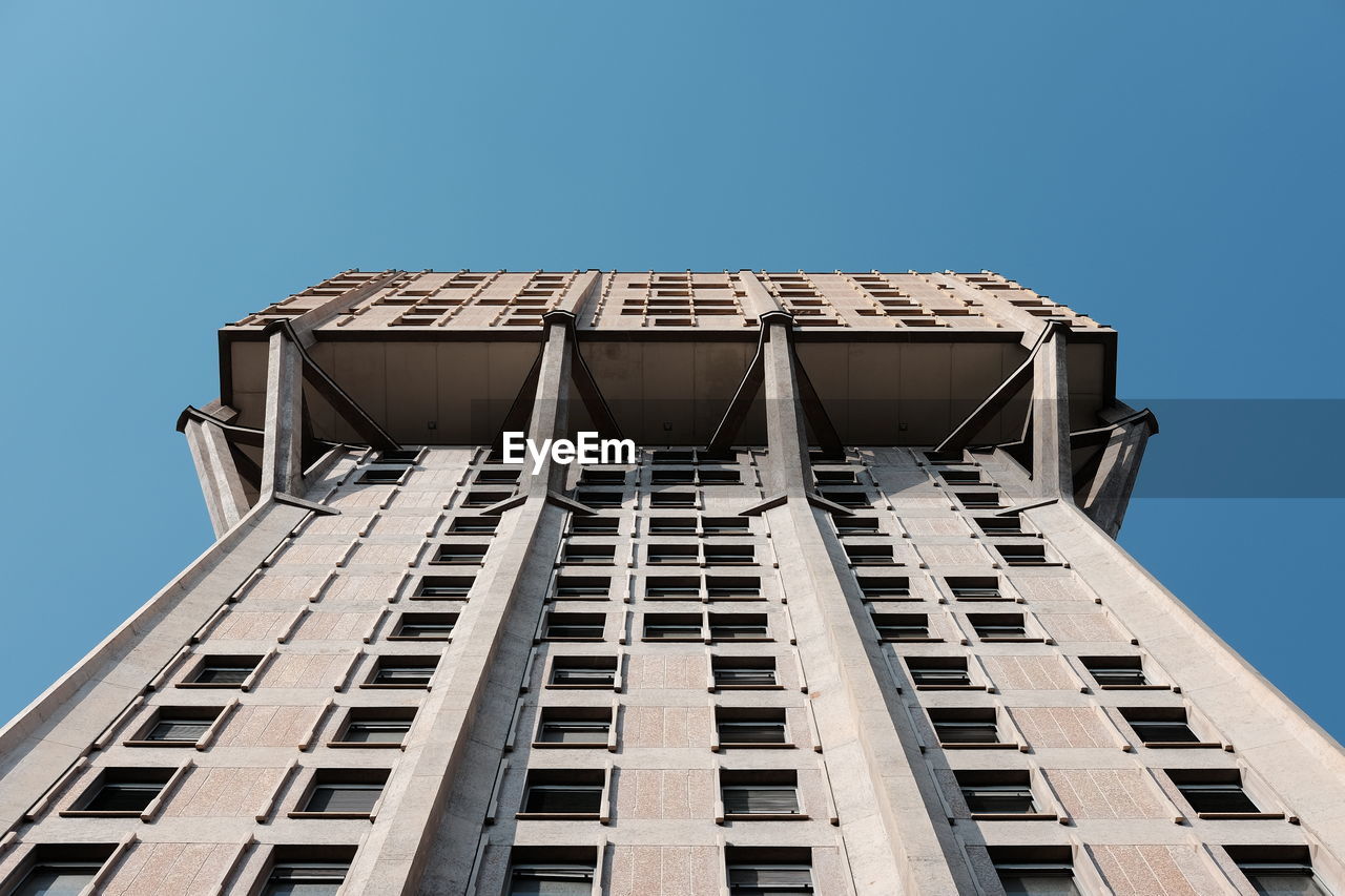 Low angle view of modern building against clear blue sky