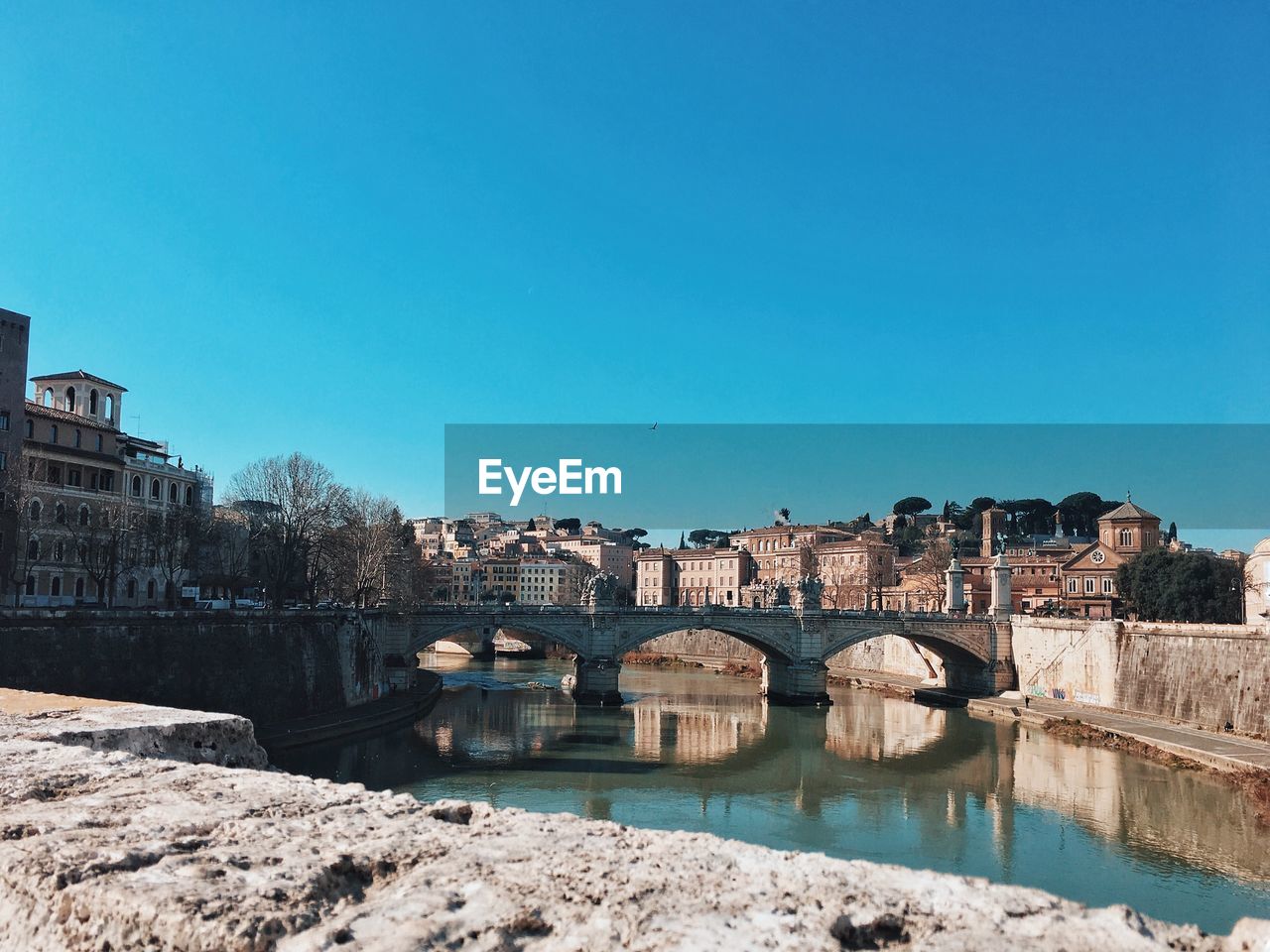 Arch bridge over river in city