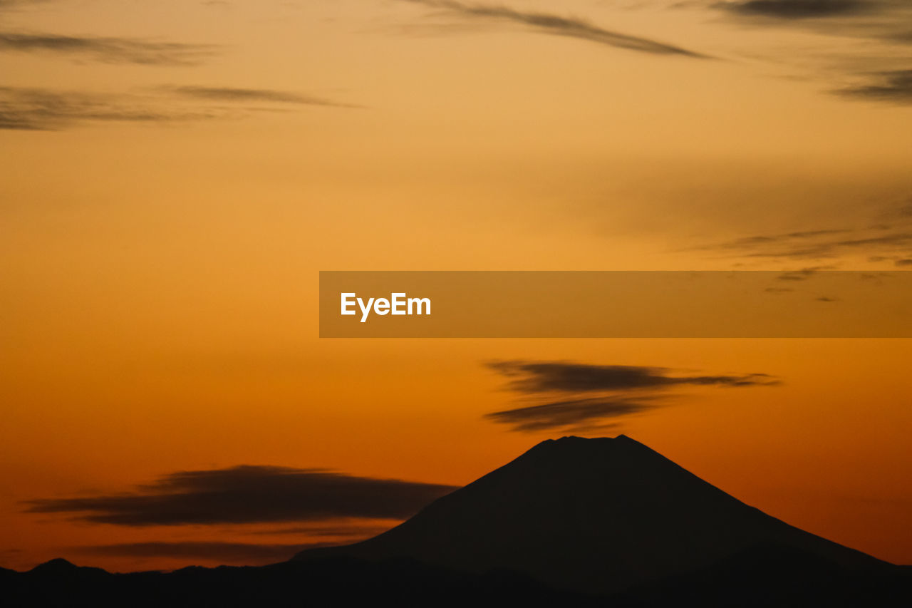 Scenic view of silhouette mountain against sky during sunset