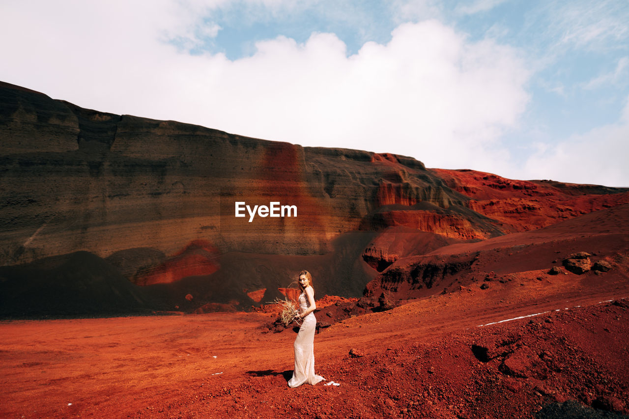 Scenic view of rock formations on land against sky