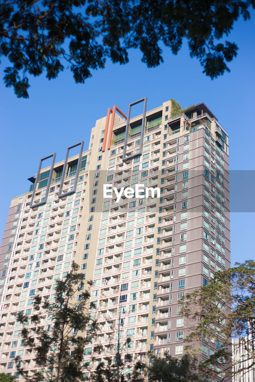 Low angle view of modern building against clear blue sky