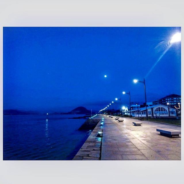 VIEW OF ILLUMINATED STREET LIGHT AGAINST SKY AT NIGHT