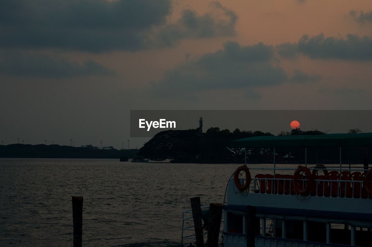 SCENIC VIEW OF SEA AGAINST ORANGE SKY