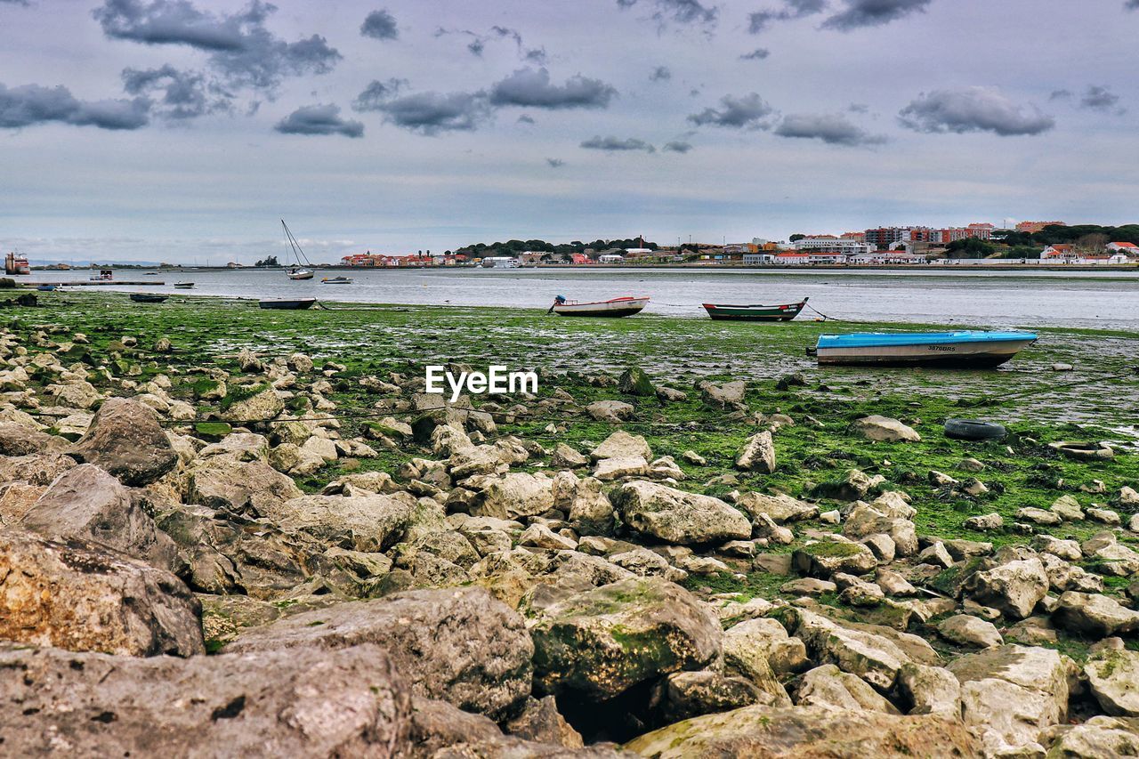 SCENIC VIEW OF BEACH AND BOATS AGAINST SKY