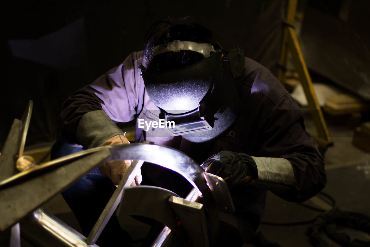 MIDSECTION OF MAN WORKING WITH UMBRELLA