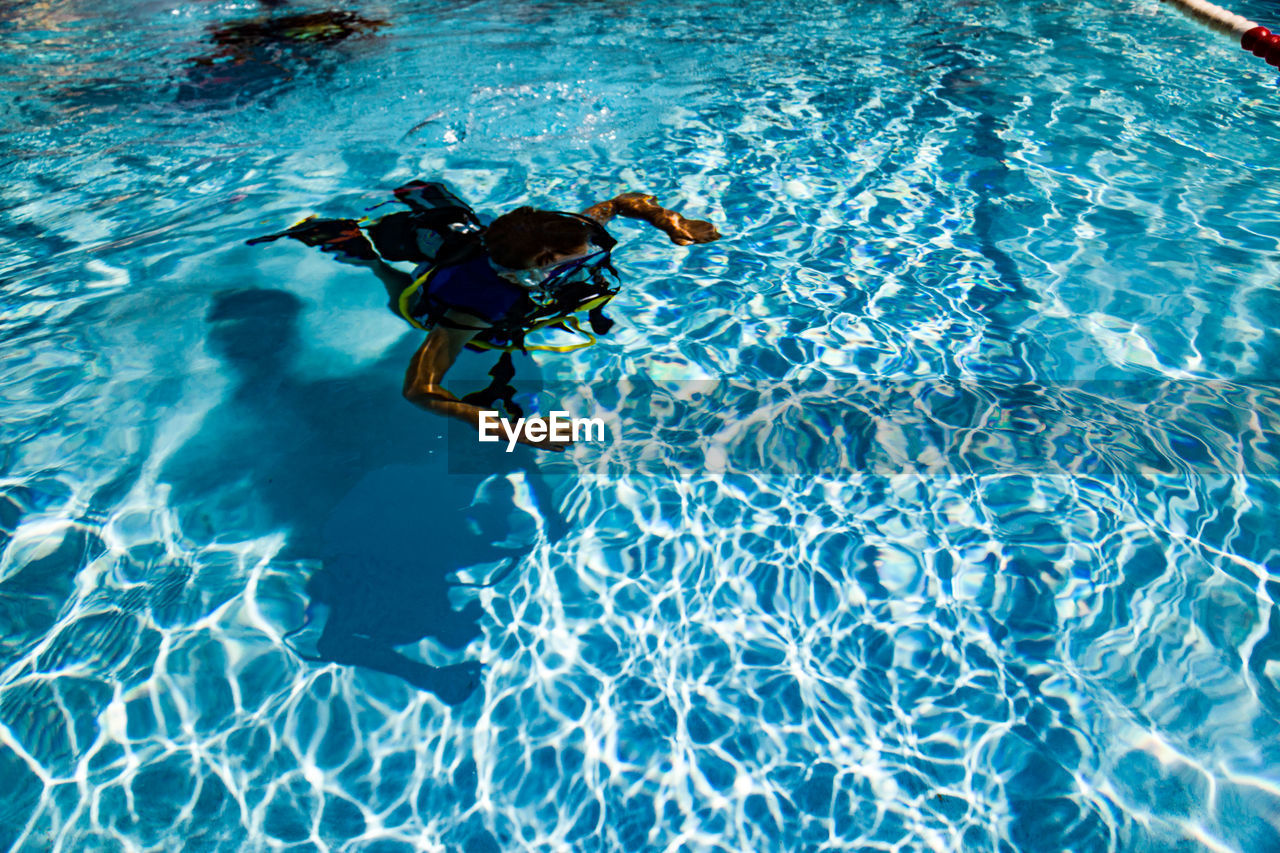 High angle view of woman swimming in pool