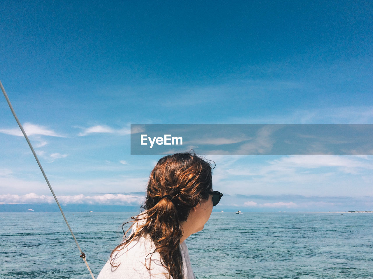 WOMAN LOOKING AT SEA SHORE