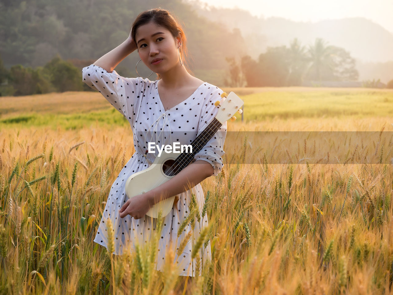 portrait of young woman standing on grassy field