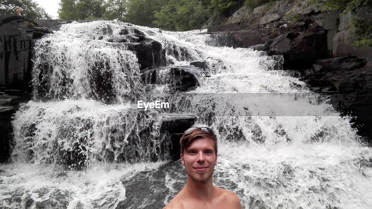 Portrait of smiling shirtless man at shohola falls