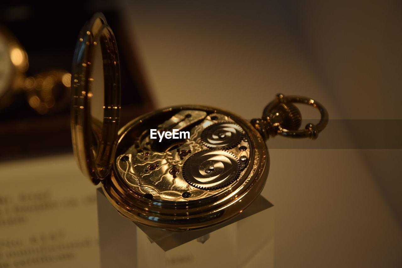 Close-up of pocket watch on table