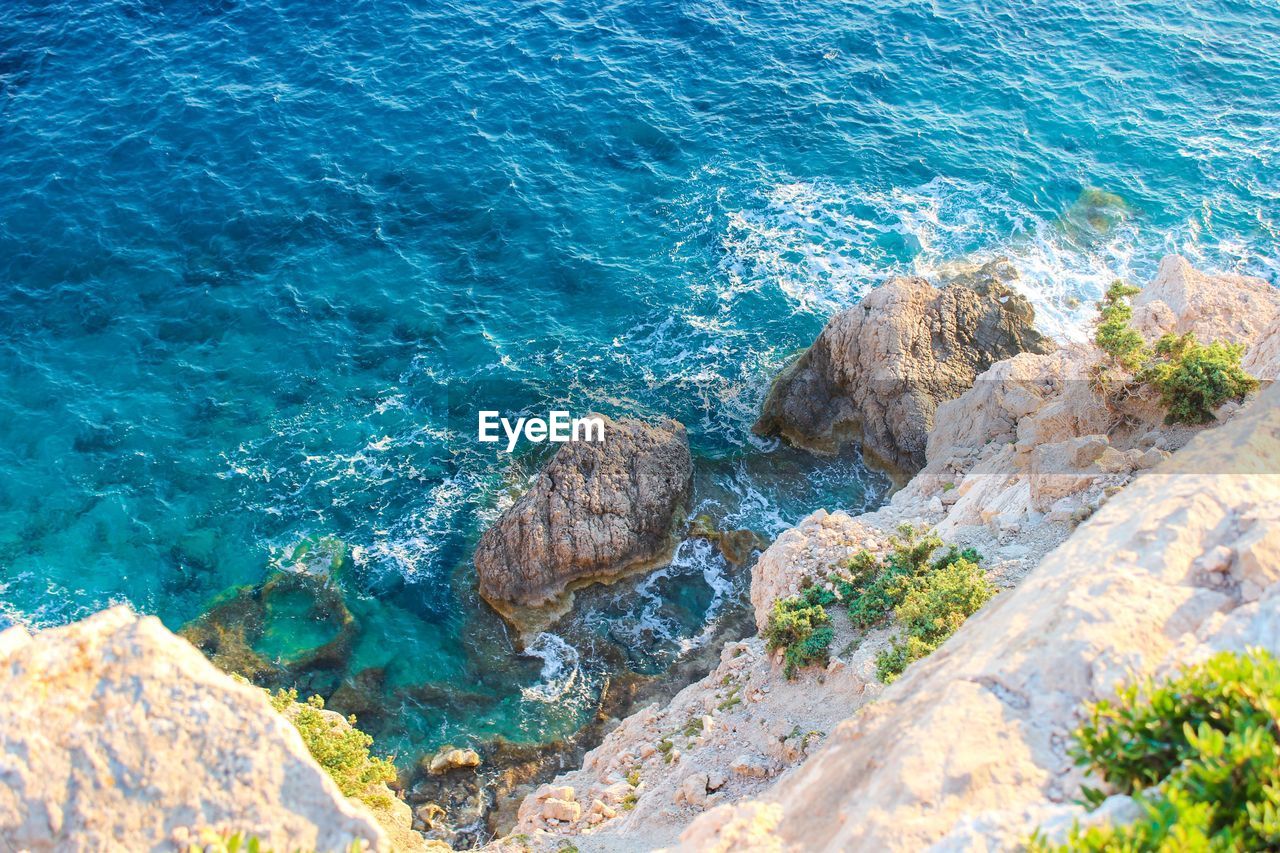 High angle view of rocks in sea