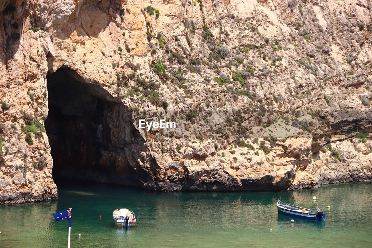 PEOPLE ON ROCKS AT SEA