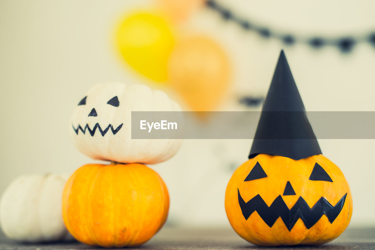 CLOSE-UP OF PUMPKINS AGAINST ORANGE PUMPKIN