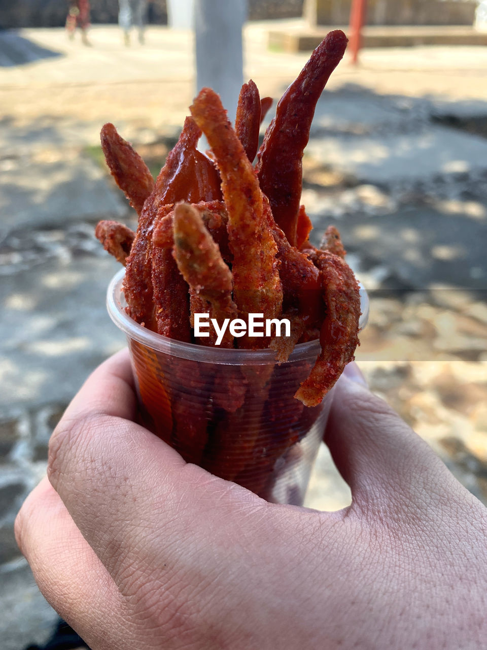 hand, one person, holding, food and drink, food, focus on foreground, day, finger, close-up, personal perspective, unhealthy eating, freshness, sweet food, leisure activity, outdoors, lifestyles, city, leaf, sweet, cone, nature, adult