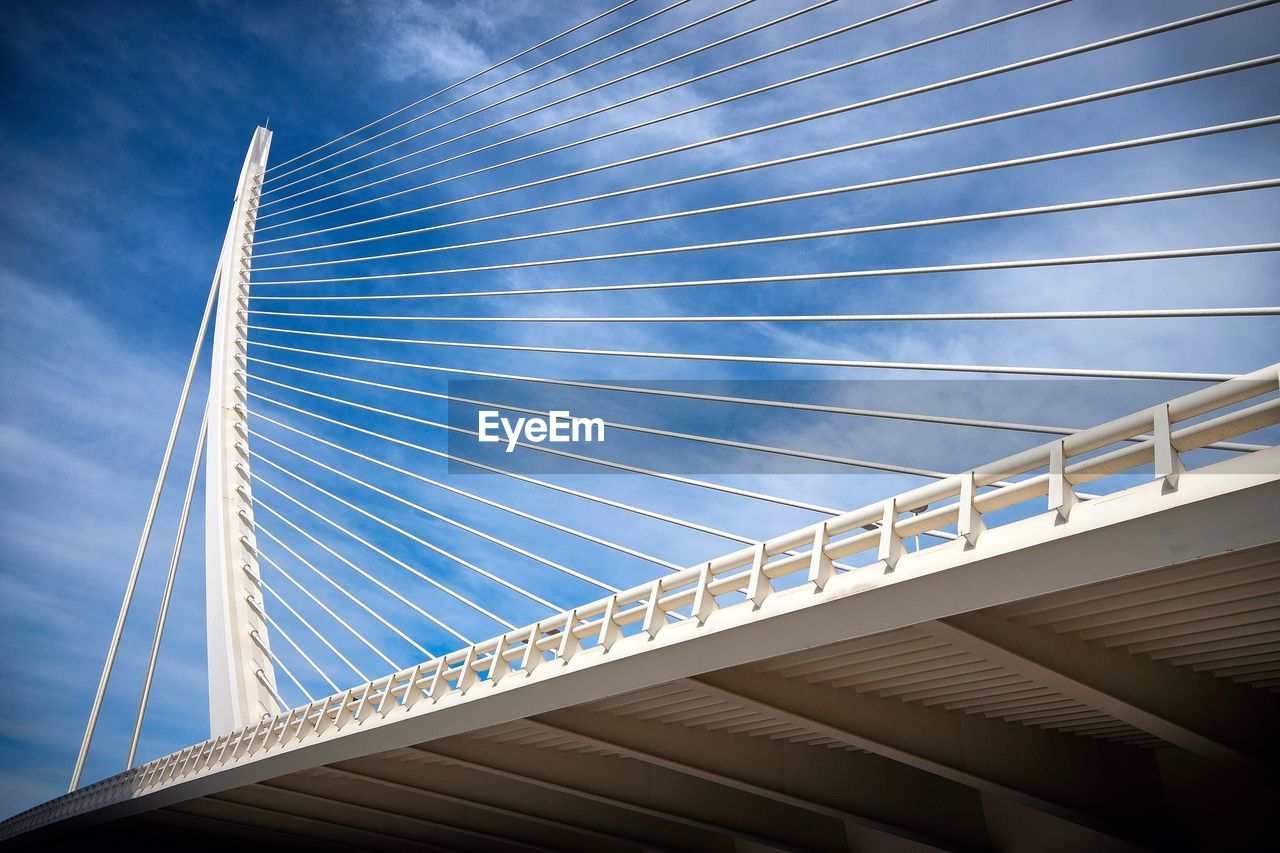 Low angle view of suspension bridge against sky