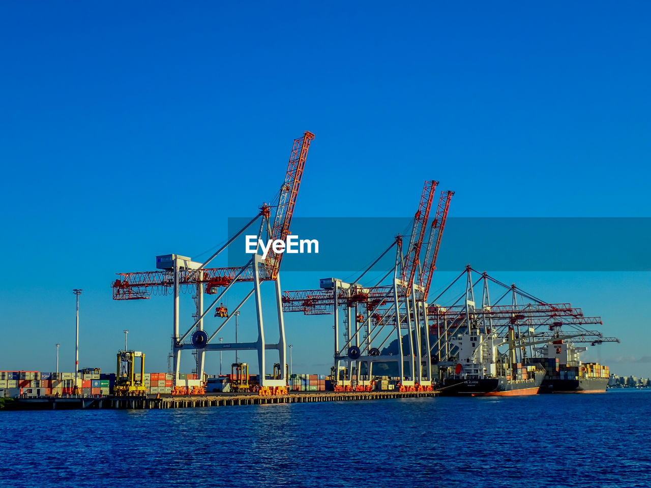 CRANES AT COMMERCIAL DOCK AGAINST CLEAR SKY