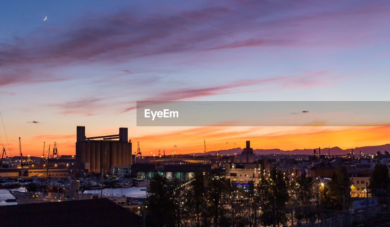 High angle view of illuminated buildings against sky during sunset